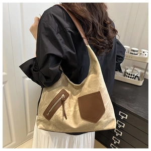 Detail of vintage canvas tote bag with brown leather trim and zipper pocket