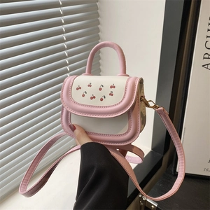 Pink and white patchwork cherry print crossbody bag with top handle and shoulder strap