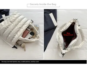 Detail showing the spacious interior and capacity of the white quilted puffer tote bag