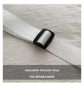 Close-up of a white woven adjustable shoulder strap with a black plastic buckle
