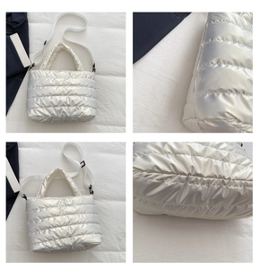 Detail view of silver quilted tote bag showing padded texture and adjustable strap