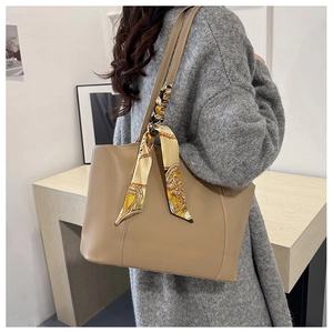 Detail of khaki tote bag with vintage printed silk scarf and long shoulder straps