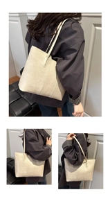 Detailed view of an off-white large tote bag with textured synthetic leather and long straps