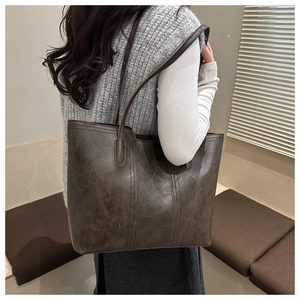 Detail of vintage large brown tote bag with double stitching and thin shoulder strap