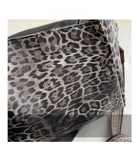 Detail view of leopard print tote bag with gold studs and woven jacquard strap