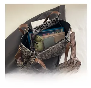 Top view of a leopard print tote bag interior showing large capacity and organizational pockets