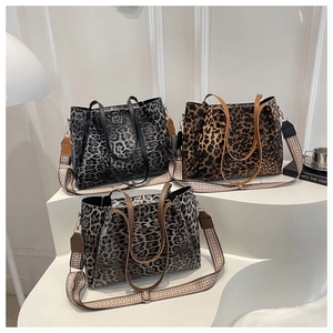 Detail of leopard print tote bags with ethnic woven straps on geometric displays