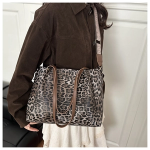 Detail of leopard print tote bag with jacquard strap and premium leather texture