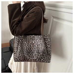 Detail view of large leopard print tote bag with premium synthetic leather texture