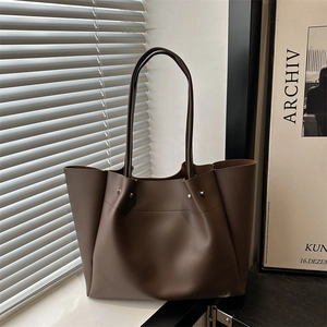 Retro deep brown leather tote bag with pleated side rivets and minimalist shoulder strap