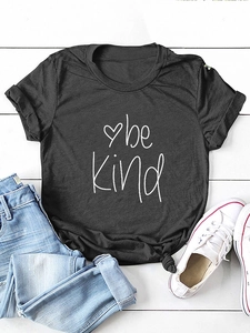 Detail of black cotton T-shirt featuring Be Kind print with knotted hem and casual styling