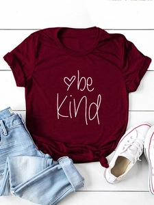 Close-up of burgundy 'be kind' t-shirt with rolled sleeves and front knot detail