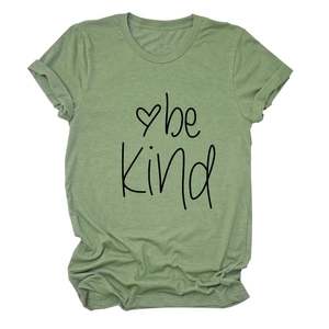 Close-up of sage green Be Kind t-shirt showing rolled sleeve and soft fabric texture