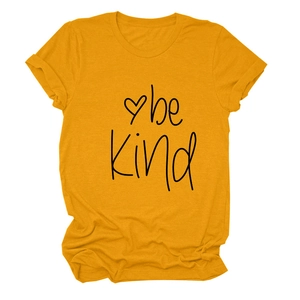 Detailed close-up of yellow cotton T-shirt featuring Be Kind print and heart design