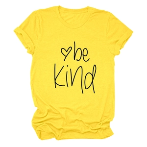 Detail of Be Kind print and heart graphic on a bright yellow cotton t-shirt