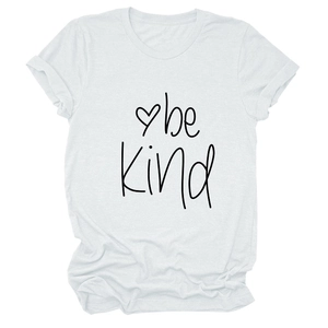 Detailed view of 'be Kind' calligraphy and heart graphic on a white cotton T-shirt
