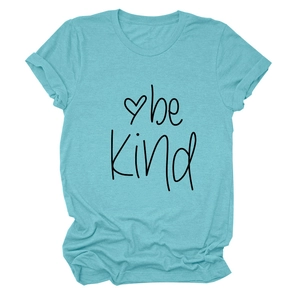 Detailed view of 'be kind' typography and heart print on teal cotton t-shirt