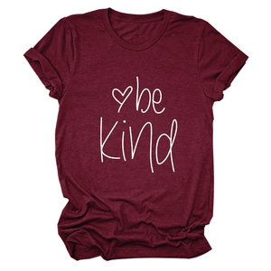 Detail of burgundy be kind printed t-shirt with rolled cuffs and heart graphic