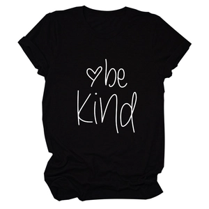 Detail of Be Kind text and heart graphic on a black cotton short sleeve T-shirt