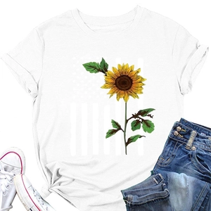 Flat lay of a white crewneck t-shirt with vibrant sunflower print and denim jeans