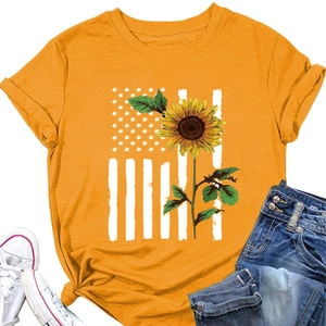 Flat lay of yellow sunflower US flag T-shirt with denim shorts and white canvas shoes