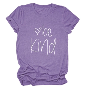 Close-up of be Kind handwritten typography and heart print on heather purple t-shirt
