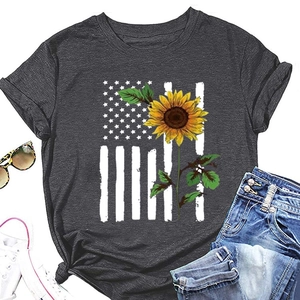 Flat lay of charcoal grey sunflower t-shirt with American flag print and denim shorts