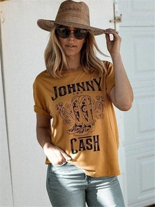 Close-up of Johnny Cash graphic tee in mustard yellow with floral western boot print