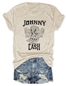 Detail of Johnny Cash graphic t-shirt and distressed denim shorts in flat lay