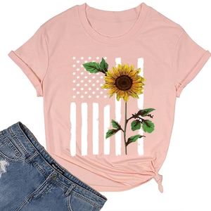 Flat lay of pink cotton T-shirt with sunflower flag print and blue denim shorts
