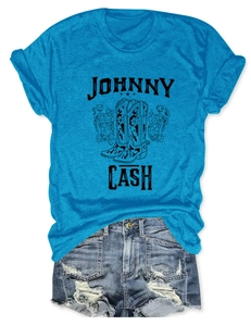 Detail of Johnny Cash graphic on blue tee with vintage cowboy boots and flowers