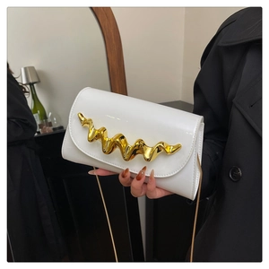 Close-up of a white patent leather handbag with a gold wave-shaped metal buckle detail