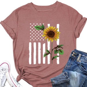 Flat lay of pink t-shirt with sunflower and American flag print, jeans and shoes