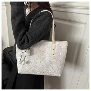 Detail of star printed tote bag with white pleat texture and plush cloud pendant
