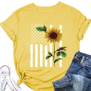 Flat lay of yellow sunflower American flag T-shirt with denim shorts and sneakers