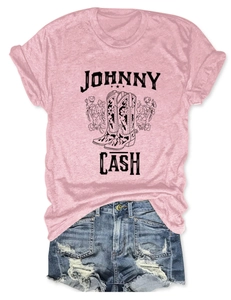 Detailed view of pink Johnny Cash graphic t-shirt with floral boots and ripped denim shorts