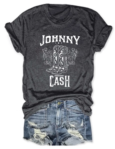 Johnny Cash graphic tee with vintage boots and flowers paired with distressed denim shorts