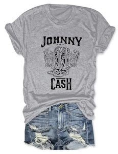 Flat lay of Johnny Cash graphic grey t-shirt with floral boots and distressed denim shorts