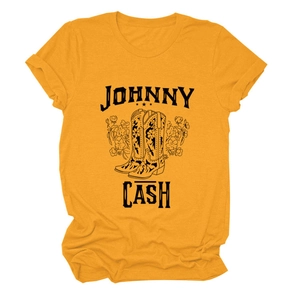 Close-up of Johnny Cash graphic print with cowboy boots and flowers on yellow cotton tee