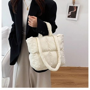 Detail of soft white quilted puffy tote bag featuring large capacity and lightweight design
