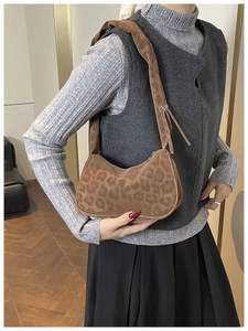 Dettaglio della borsa leopardata in peluche con tracolla larga e design curvo
