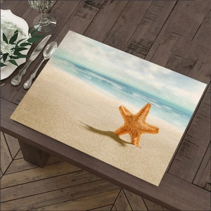 Rechthoekige linnen placemat met zeesterprint op donkerhouten tafel met bestek