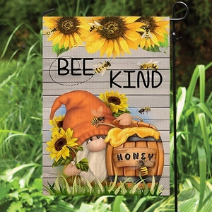 Summer garden gnome flag with sunflowers and bee kind text on a metal stand outdoors