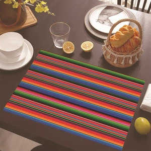 Mexican Serape style colorful striped linen placemat on dark wooden dining table