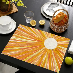Macro detail of Mexican linen placemat with vibrant orange sunburst pattern on wooden table