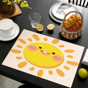 Linen placemat with cartoon sun pattern on a black wooden dining table with tableware