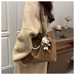 Dettaglio borsa tote in pelle scamosciata leopardata con catena di perle e logo