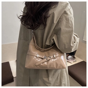 Rear view of khaki patent leather underarm bag with decorative belt buckle and metal hardware