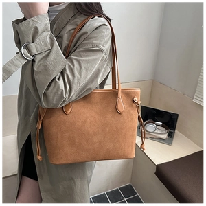 Brown frosted leather tote bag detail with side drawstring and smooth shoulder strap