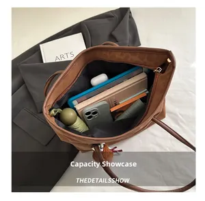 Spacious interior of brown tote bag showing capacity for tablet, notebook and daily items